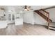 Open-concept floorplan with wood floors, staircase, and abundant natural light at 1514 S Ouray Cir # B, Aurora, CO 80017