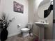 Charming powder room with pedestal sink, decorative mirror, and stylish wall accents at 2351 Monte Vista St, Fort Lupton, CO 80621