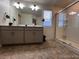 Well lit bathroom featuring double vanity sink, shower, and tile flooring at 2351 Monte Vista St, Fort Lupton, CO 80621