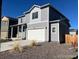 Charming two-story home with gray siding and a two-car garage, plus low maintenance front yard at 2351 Monte Vista St, Fort Lupton, CO 80621