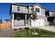 Two-story house with new gray siding, a front porch, a two-car garage and newly planted landscaping at 2351 Monte Vista St, Fort Lupton, CO 80621