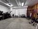 Organized garage space with workbench, gym equipment, and clean concrete floors at 2351 Monte Vista St, Fort Lupton, CO 80621