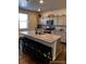 Modern kitchen featuring a large granite countertop island with seating and stylish gray cabinets at 2351 Monte Vista St, Fort Lupton, CO 80621