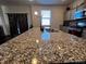 Modern kitchen featuring a large granite countertop island and stylish gray cabinets at 2351 Monte Vista St, Fort Lupton, CO 80621