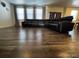 Spacious living room featuring wood floors and a large sectional couch at 2351 Monte Vista St, Fort Lupton, CO 80621