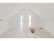 Attic space featuring windows offering natural light and white painted finishes at 3901 Alcott St, Denver, CO 80211