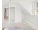 Freshly painted attic featuring clean white walls, floors, and a window at 3901 Alcott St, Denver, CO 80211
