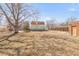 View of a large backyard showing the exterior of the home, a shed, and a fence at 3901 Alcott St, Denver, CO 80211