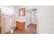 Modest bathroom featuring a wood vanity, mirrored cabinet, and separate shower room at 3901 Alcott St, Denver, CO 80211