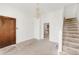 Bright living room featuring an open doorway, chandelier, and staircase at 3901 Alcott St, Denver, CO 80211