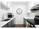 Well-lit modern kitchen with sleek black appliances and tiled backsplash at 1313 N Williams St # 301, Denver, CO 80218