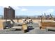 Inviting rooftop deck with lounge chairs and panoramic views of the city skyline and snow-capped mountains at 1313 N Williams St # 301, Denver, CO 80218