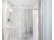 Modern shower with glass door, sleek fixtures, and stylish gray tile at 1313 N Williams St # 301, Denver, CO 80218