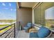 Inviting balcony with comfortable seating and a view of the lake and landscape at 16860 Askins Loop # 102, Parker, CO 80134