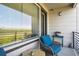 Charming balcony with serene view, comfortable chair, and accent tables at 16860 Askins Loop # 102, Parker, CO 80134