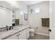 Bathroom featuring granite countertop sink vanity, white cabinets and modern fixtures at 16860 Askins Loop # 102, Parker, CO 80134