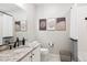 Bright bathroom featuring marble countertop, decorative art, and a shower-tub combination at 16860 Askins Loop # 102, Parker, CO 80134