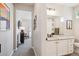 Bathroom view featuring a granite countertop sink vanity and connecting hallway at 16860 Askins Loop # 102, Parker, CO 80134