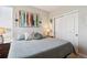 Comfortable bedroom featuring a cozy bed, colorful painting, and closet at 16860 Askins Loop # 102, Parker, CO 80134