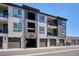 Modern townhome featuring a gray exterior with garage and balcony at 16860 Askins Loop # 102, Parker, CO 80134