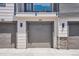 View of a gray, attached garage numbered 102 at a property at 16860 Askins Loop # 102, Parker, CO 80134