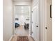 Hallway with hardwood-style floors leading to the bright, open living area at 16860 Askins Loop # 102, Parker, CO 80134