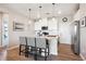 Modern kitchen with a large island, granite countertops, and white cabinets at 16860 Askins Loop # 102, Parker, CO 80134