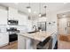 Well-equipped kitchen island with stainless appliances and seating at 16860 Askins Loop # 102, Parker, CO 80134