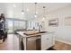 Bright kitchen features a central island with granite countertops and modern stainless steel appliances at 16860 Askins Loop # 102, Parker, CO 80134
