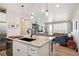 Open-concept kitchen with granite counters flows into the living area, perfect for entertaining at 16860 Askins Loop # 102, Parker, CO 80134