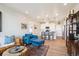 Open-concept living room with hardwood floors and contemporary decor at 16860 Askins Loop # 102, Parker, CO 80134