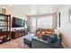 Cozy living room with comfortable seating and access to the balcony at 16860 Askins Loop # 102, Parker, CO 80134