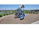 View of a playground with slide and climbing structure with a lake in the background at 16860 Askins Loop # 102, Parker, CO 80134