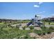 Community playground with slide and climbing structure on a sunny day at 16860 Askins Loop # 102, Parker, CO 80134