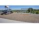 View of a playground with a slide and swings overlooking a lake and some trees at 16860 Askins Loop # 102, Parker, CO 80134