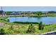 Picturesque view of a pond surrounded by lush greenery and buildings in the distance at 16860 Askins Loop # 102, Parker, CO 80134