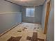Unfinished basement with blue walls and deteriorating floor tiles at 16094 E Exposition Dr, Aurora, CO 80017