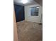Unfinished basement featuring a single, rectangular window and painted accent wall at 16094 E Exposition Dr, Aurora, CO 80017