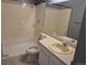 Bathroom with a shower, toilet, sink, and mirror at 16094 E Exposition Dr, Aurora, CO 80017