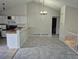 Open dining area with bright interior, chandelier, and access to kitchen and stairs at 16094 E Exposition Dr, Aurora, CO 80017