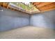Unfinished basement view showcasing a gray concrete wall and gravel flooring at 15175 Rainbow Dr, Sedalia, CO 80135