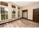Bedroom with floor to ceiling windows, dark stained trim and a closet at 15175 Rainbow Dr, Sedalia, CO 80135