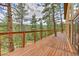 Large wooden deck with cable railing overlooking wooded views at 15175 Rainbow Dr, Sedalia, CO 80135