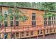 Modern home featuring a spacious wooden deck and surrounded by lush trees at 15175 Rainbow Dr, Sedalia, CO 80135