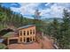 Modern two-story home with a light wood exterior, attached garage and beautiful treed mountain views at 15175 Rainbow Dr, Sedalia, CO 80135