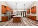 Modern kitchen with an island, stainless appliances, custom cabinets, hardwood floors, and double french doors at 15175 Rainbow Dr, Sedalia, CO 80135