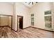 Spacious room with high ceilings and wood-look floors offering backyard views through multiple windows at 15175 Rainbow Dr, Sedalia, CO 80135
