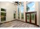 Open living room featuring many windows and french doors that allow plenty of natural light and backyard views at 15175 Rainbow Dr, Sedalia, CO 80135