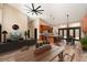 Open-concept living space featuring a modern kitchen, dining area and a comfortable sitting area, all with hardwood floors at 15175 Rainbow Dr, Sedalia, CO 80135