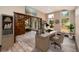 Bright home office space with a wood desk, built-in bookcase, wood floors, large windows and staircase at 15175 Rainbow Dr, Sedalia, CO 80135